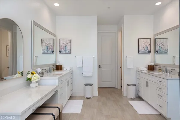 a spacious bathroom with a granite countertop sink a toilet a mirror shower and vanity