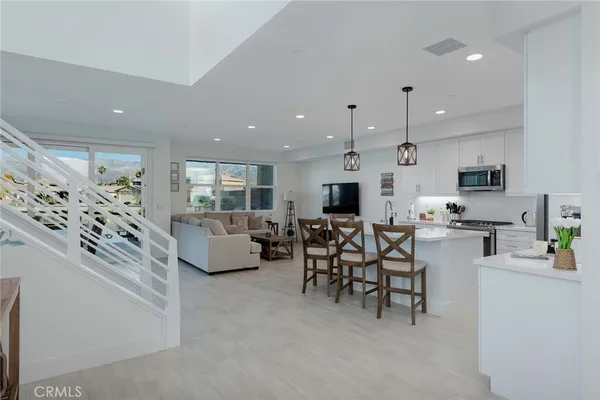 a large white kitchen with stainless steel appliances