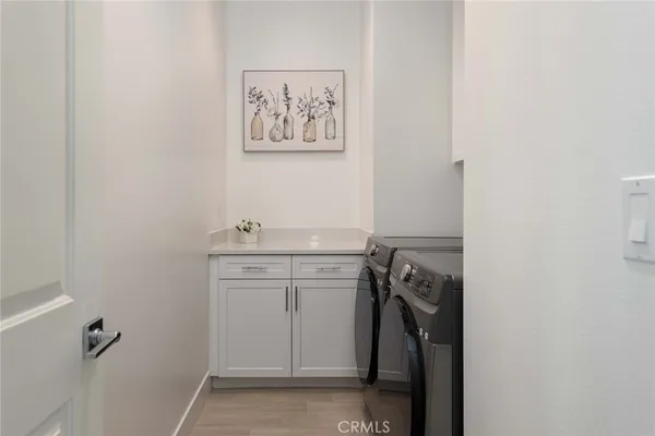 a utility room with a sink dryer and washer