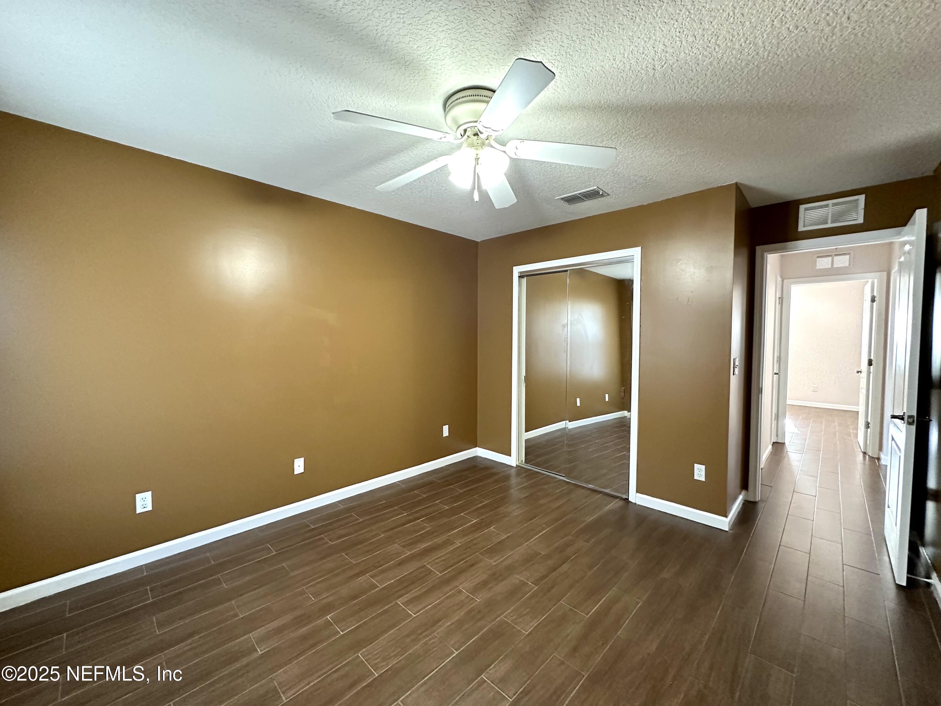 45575 Ingleham Circle Callahan, FL 32011 - Photo 13 of 24 wooden floor in an empty room with a window