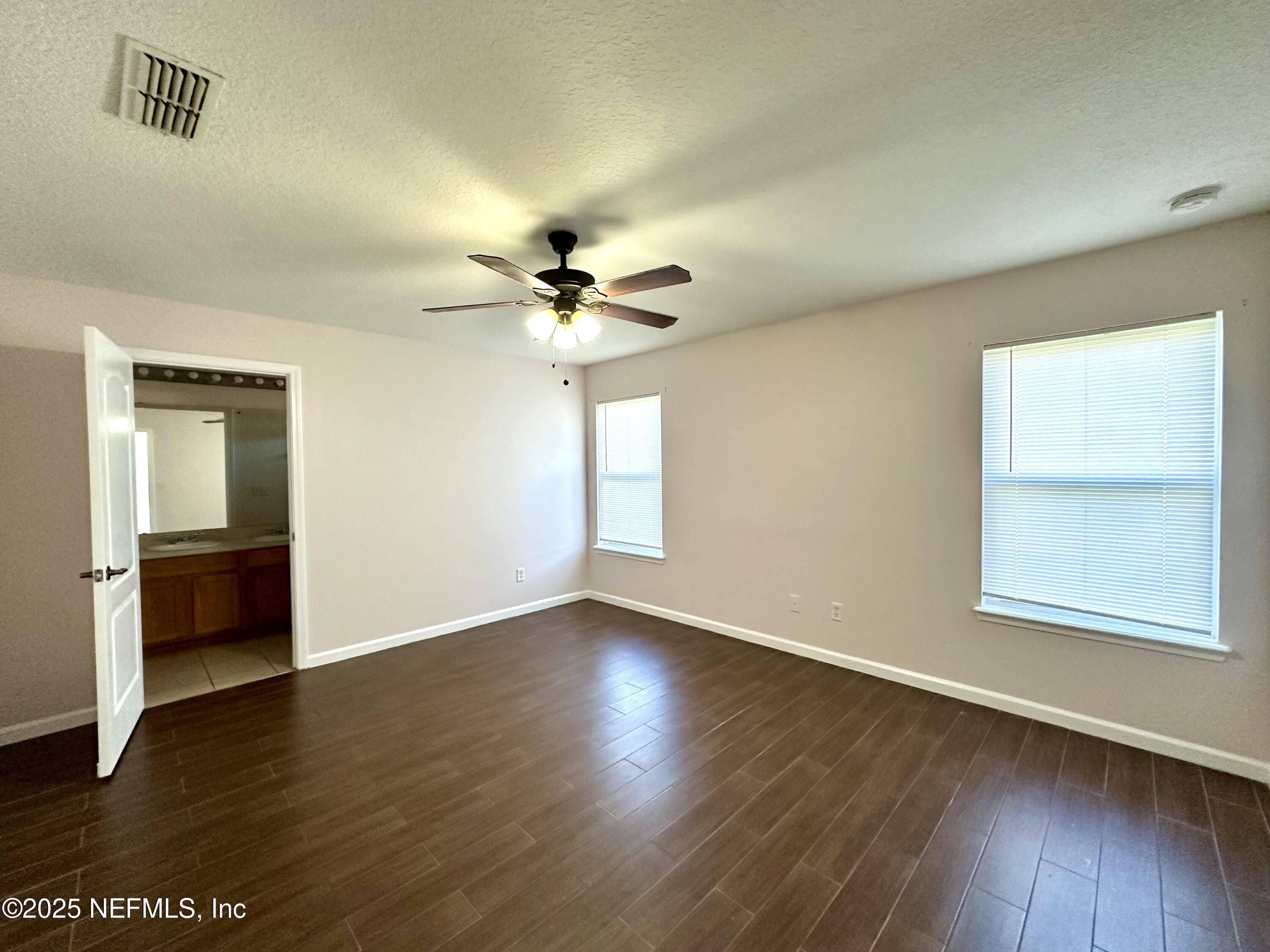 45575 Ingleham Circle Callahan, FL 32011 - Photo 14 of 24 a view of an empty room with wooden floor and a window