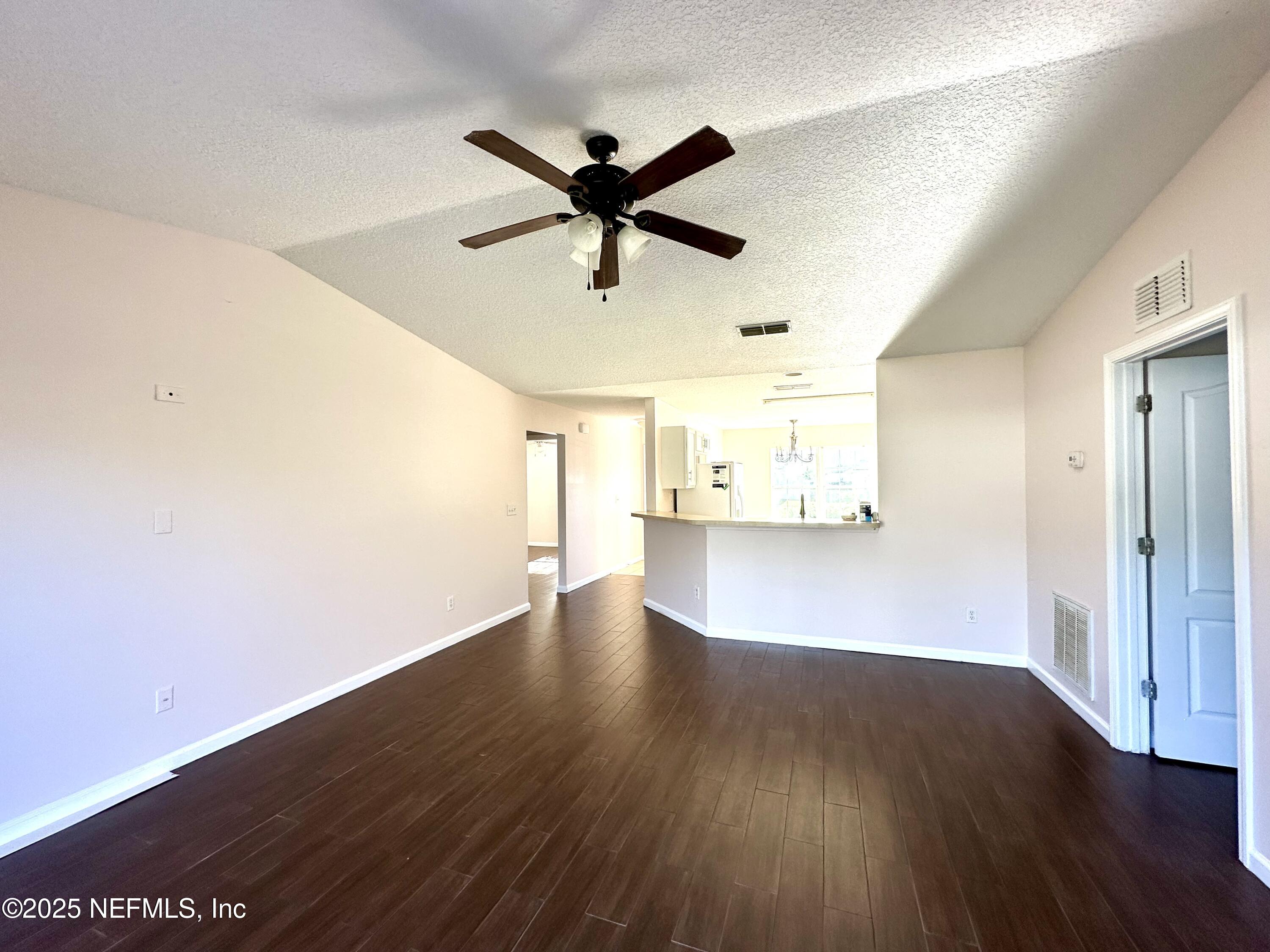 45575 Ingleham Circle Callahan, FL 32011 - Photo 2 of 24 a view of a big room with wooden floor and windows