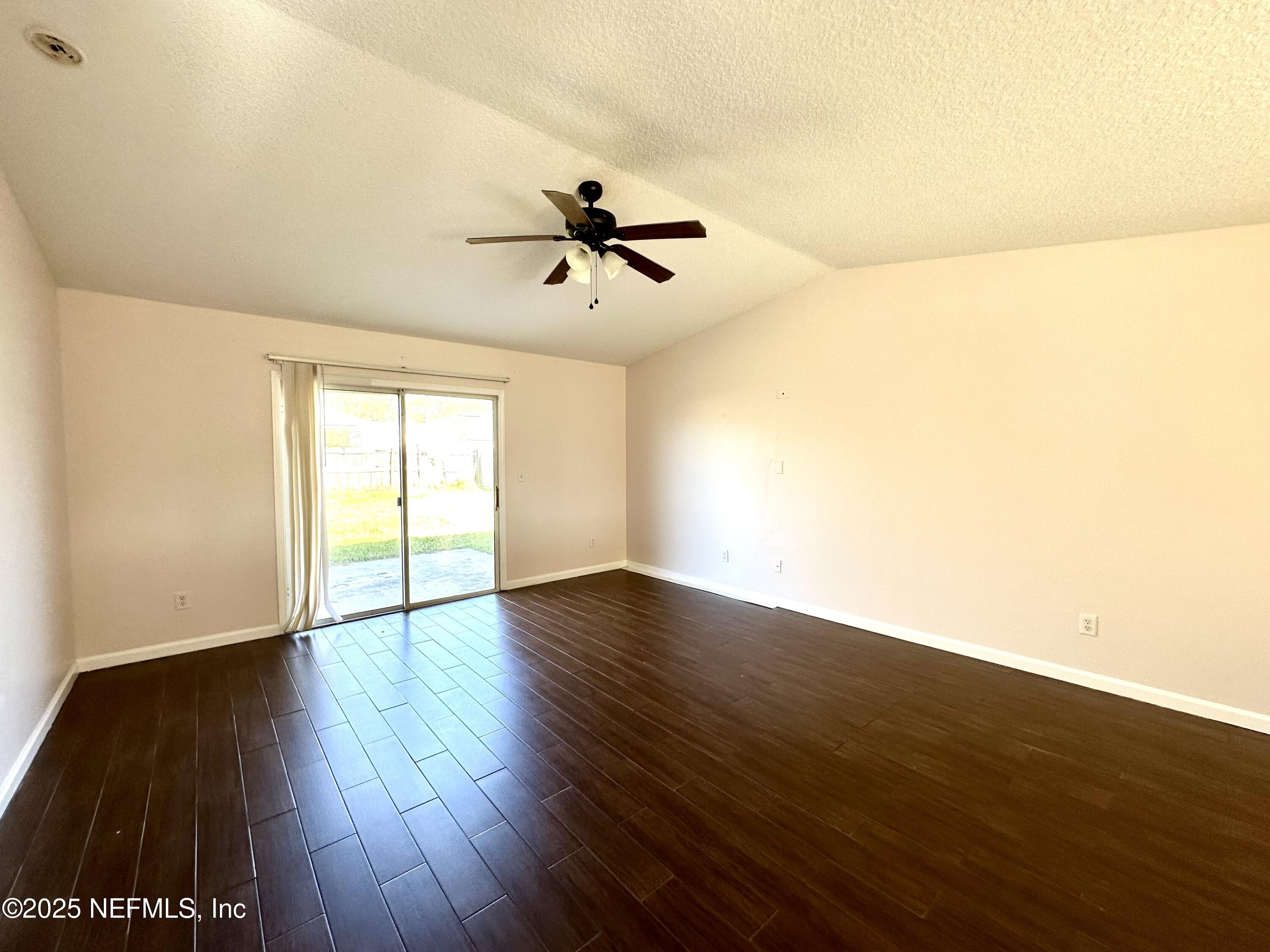 45575 Ingleham Circle Callahan, FL 32011 - Photo 3 of 24 a view of room with hardwood floor and a ceiling fan