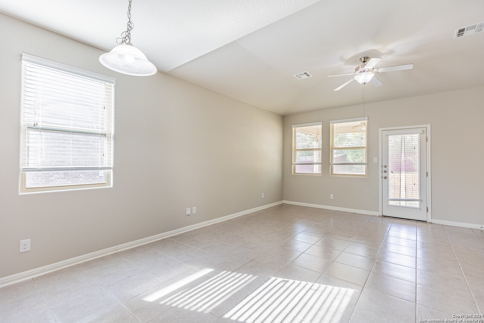 8527 Rolling Tree Converse, TX 78109 - Photo 12 of 40 a view of an empty room with a window and wooden floor