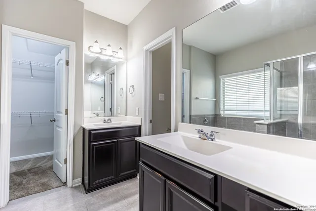 a bathroom with a sink double vanity and a mirror