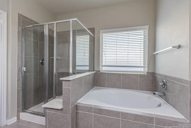 a bathroom with a tub and shower