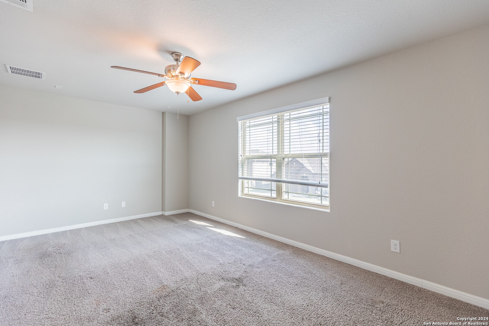 8527 Rolling Tree Converse, TX 78109 - Photo 25 of 40 an empty room with windows and fan chandelier fan