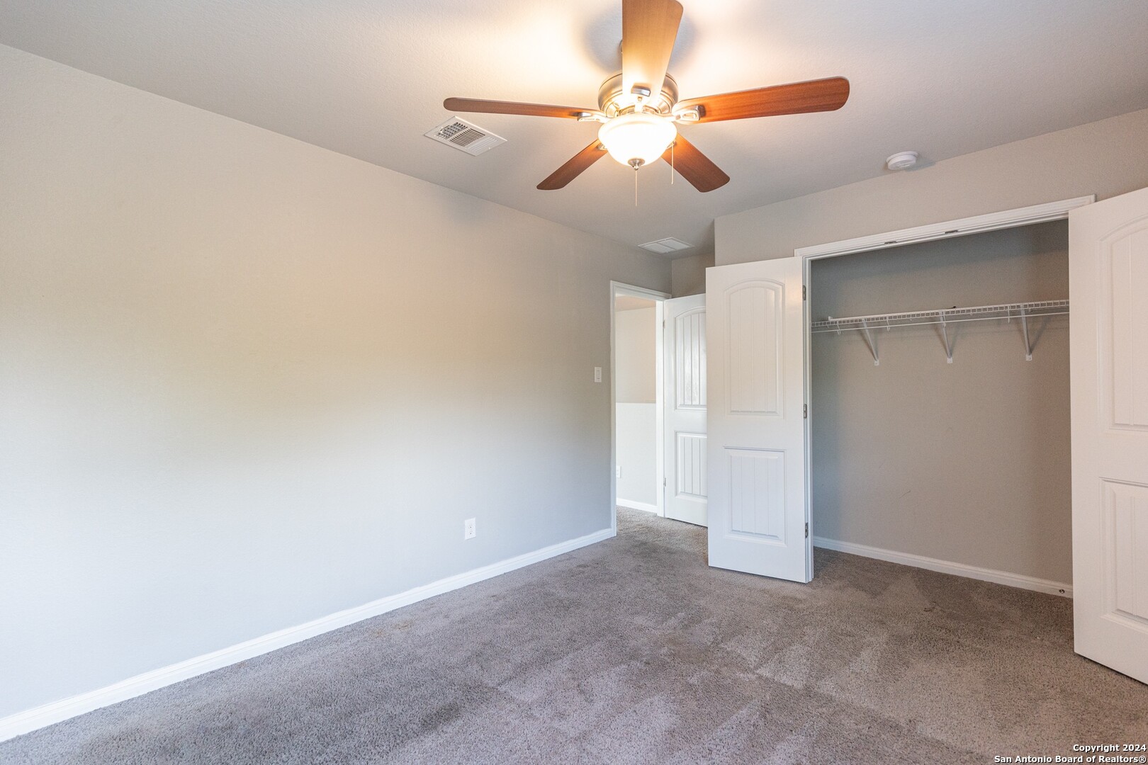 8527 Rolling Tree Converse, TX 78109 - Photo 32 of 40 an empty room with closet and a chandelier fan