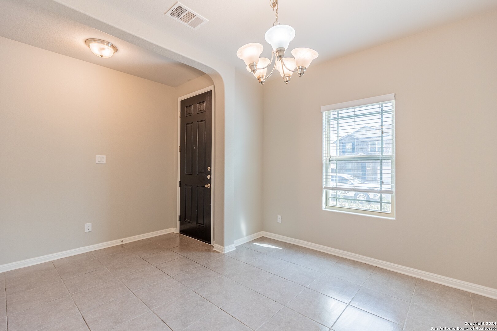 8527 Rolling Tree Converse, TX 78109 - Photo 7 of 40 an empty room with chandelier fan and windows