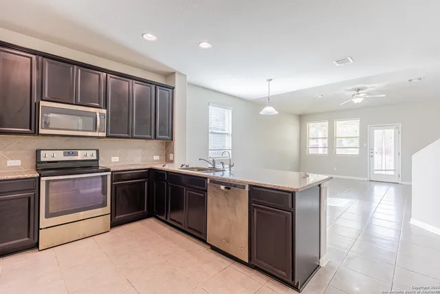 a kitchen with stainless steel appliances granite countertop a stove and a sink