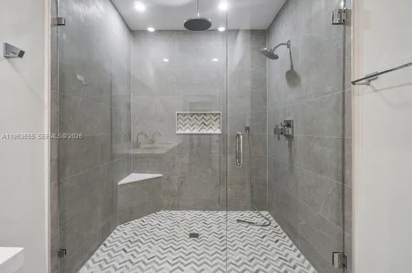 a view of a balcony with floor to ceiling windows with wooden fence