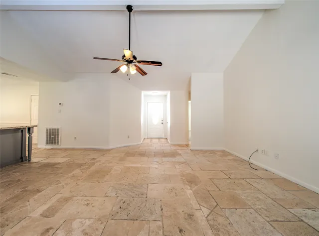 a view of an empty room with a fan