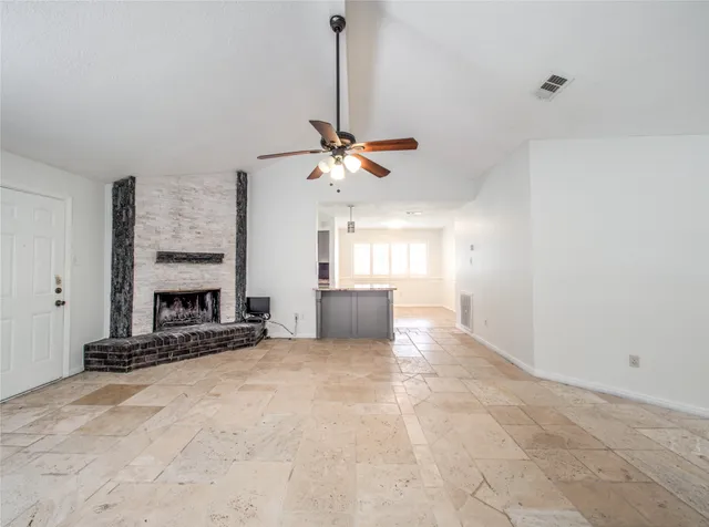 a view of a livingroom with a fireplace and a chandelier