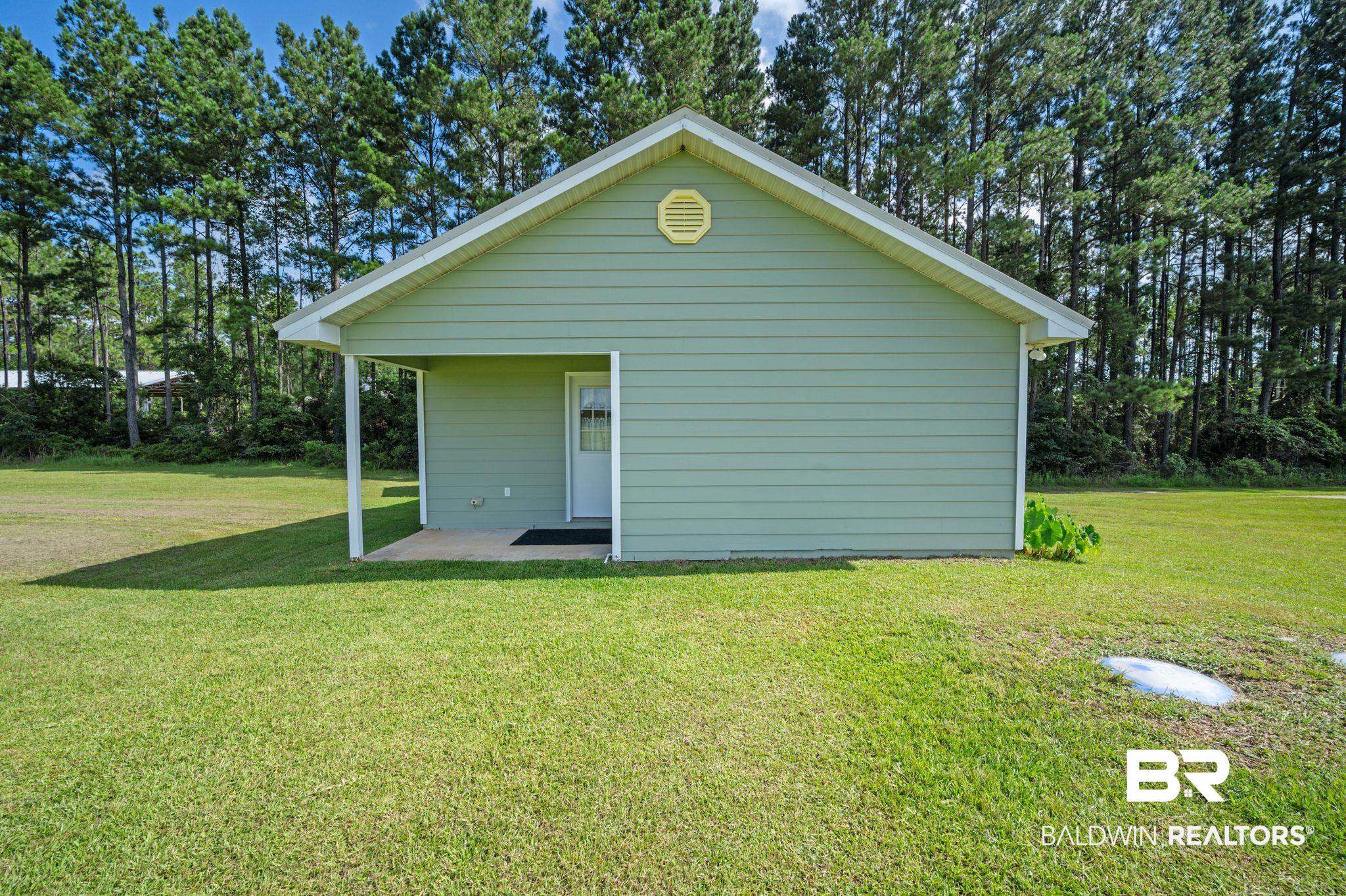 48513 Phillipsville Road Bay Minette, AL 36507 - Photo 31 of 50 Rear view of house featuring a yard