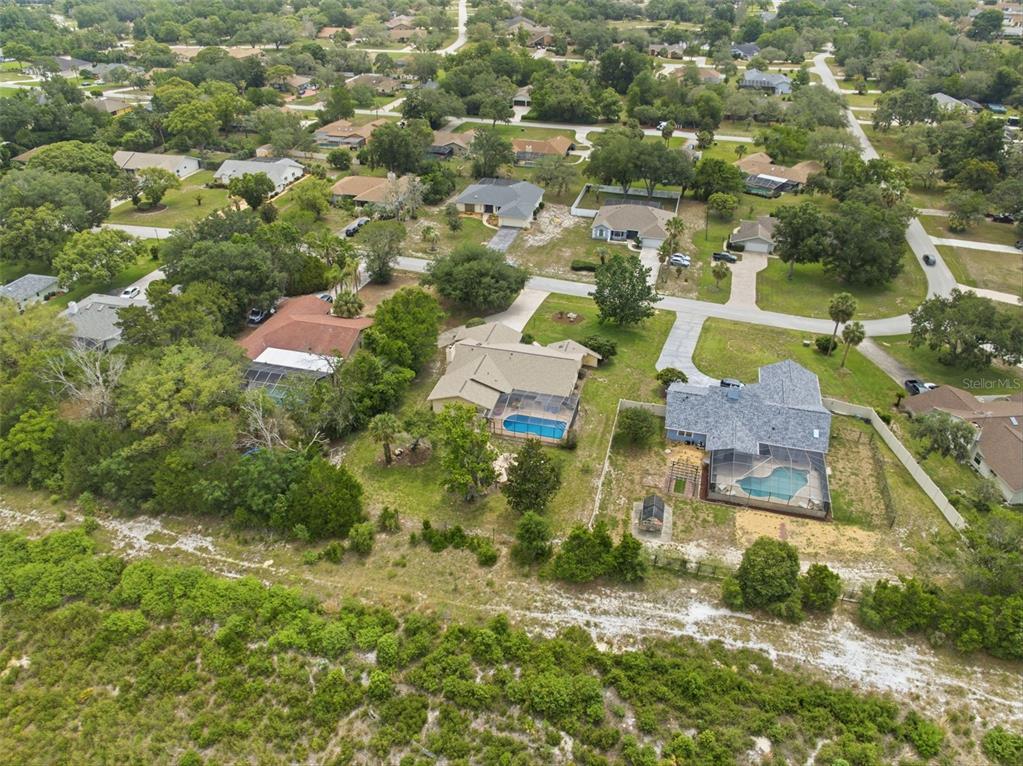 5227 Suwannee Road Weeki Wachee, FL 34607 - Photo 58 of 62 an aerial view of residential houses with outdoor space and trees