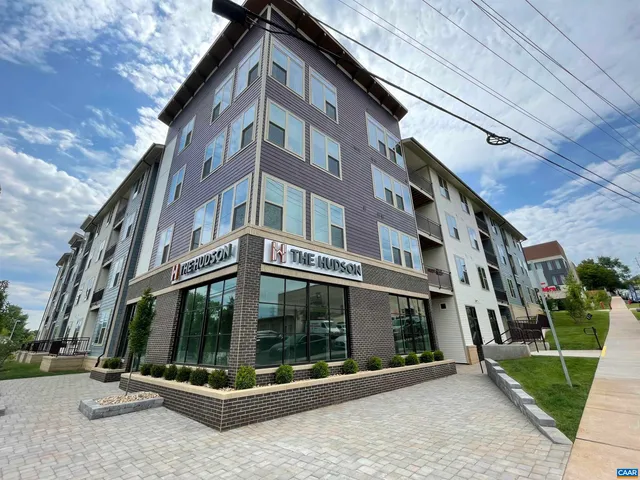 a view of a building with a small yard