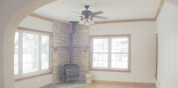 9432 East Scott Road Stillman Valley, IL 61084 - Photo 3 of 6 an empty room with a chandelier fan and windows