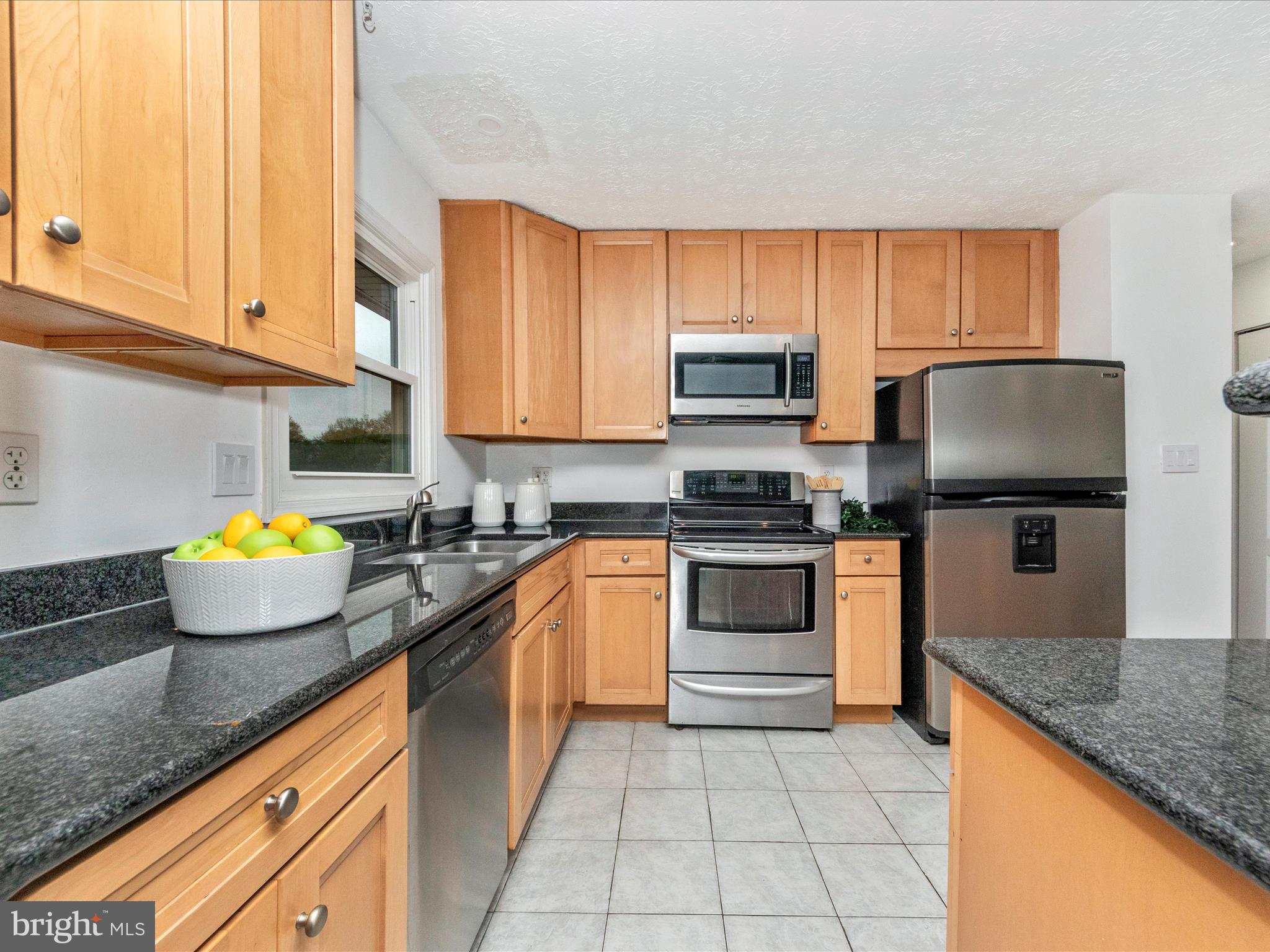 1825 Montreal Road Severn, MD 21144 - Photo 15 of 51 a kitchen with stainless steel appliances granite countertop a stove sink and cabinets