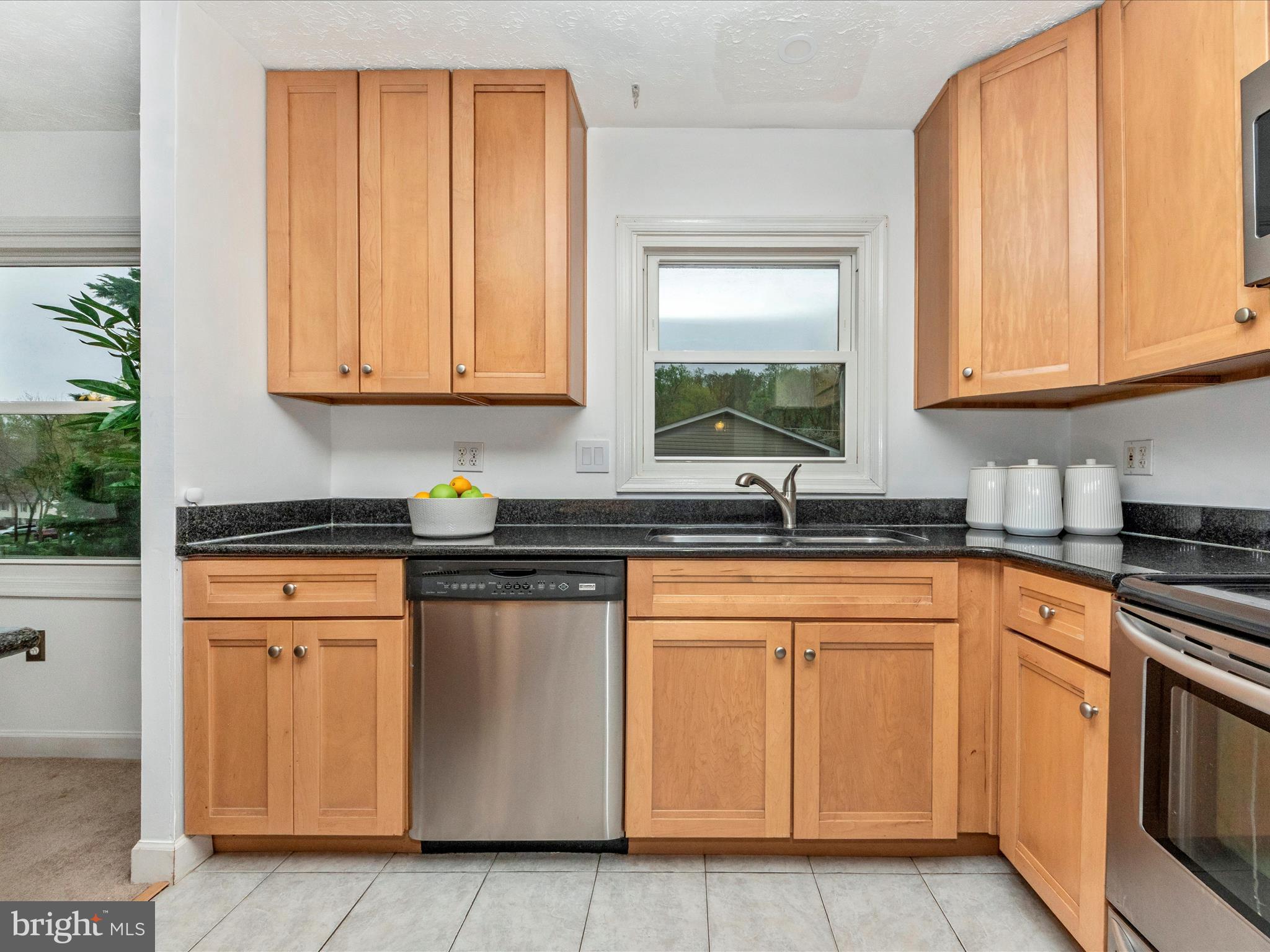 1825 Montreal Road Severn, MD 21144 - Photo 17 of 51 a kitchen with stainless steel appliances granite countertop a stove a sink and a white cabinets