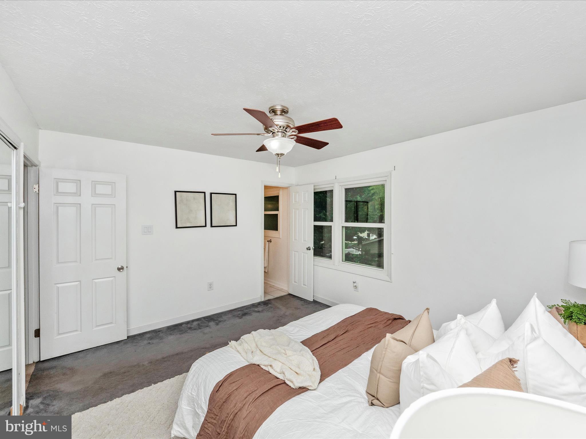 1825 Montreal Road Severn, MD 21144 - Photo 21 of 51 a bedroom with a large bed chandelier and a window