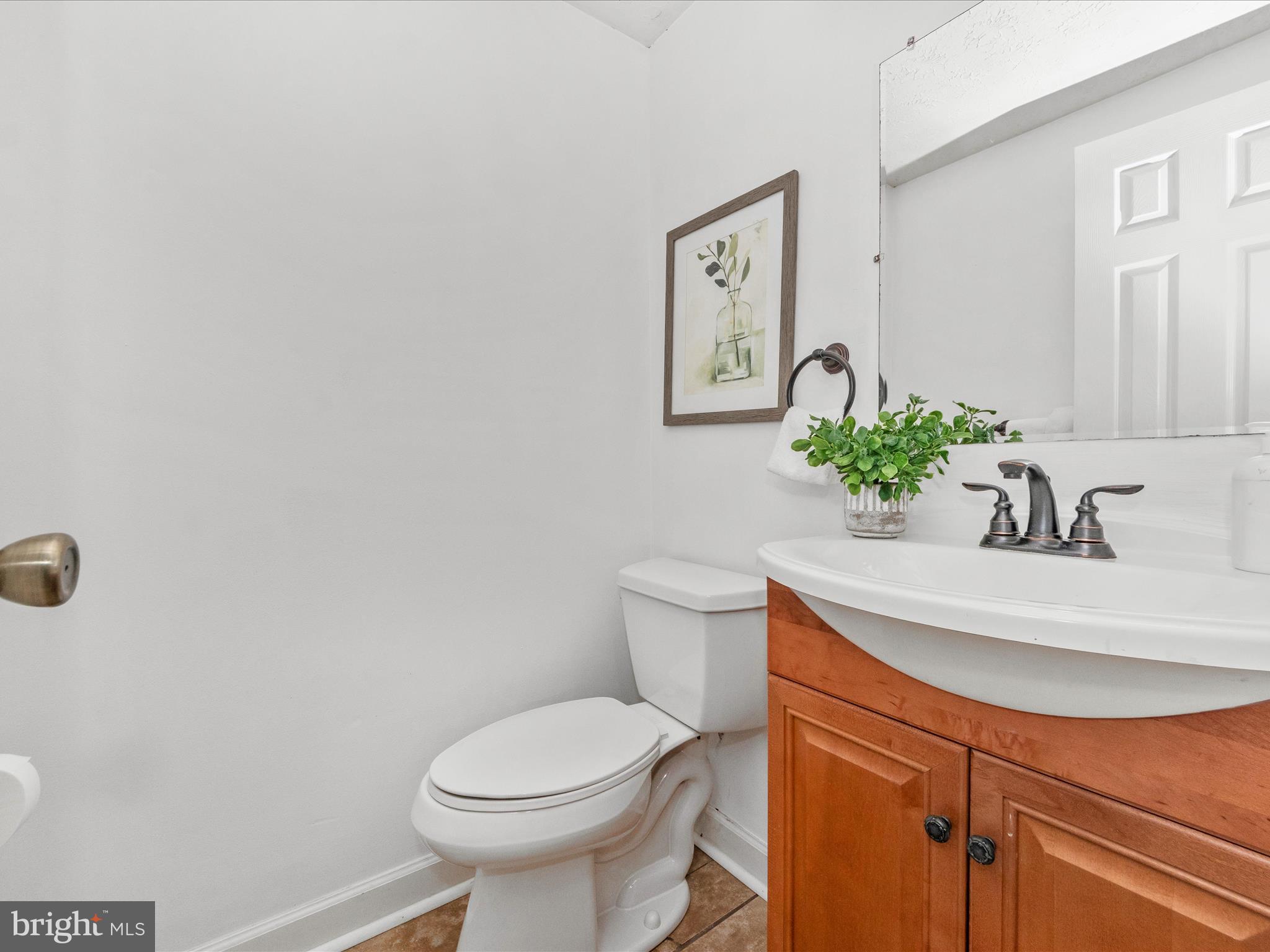 1825 Montreal Road Severn, MD 21144 - Photo 37 of 51 a bathroom with a sink mirror and toilet