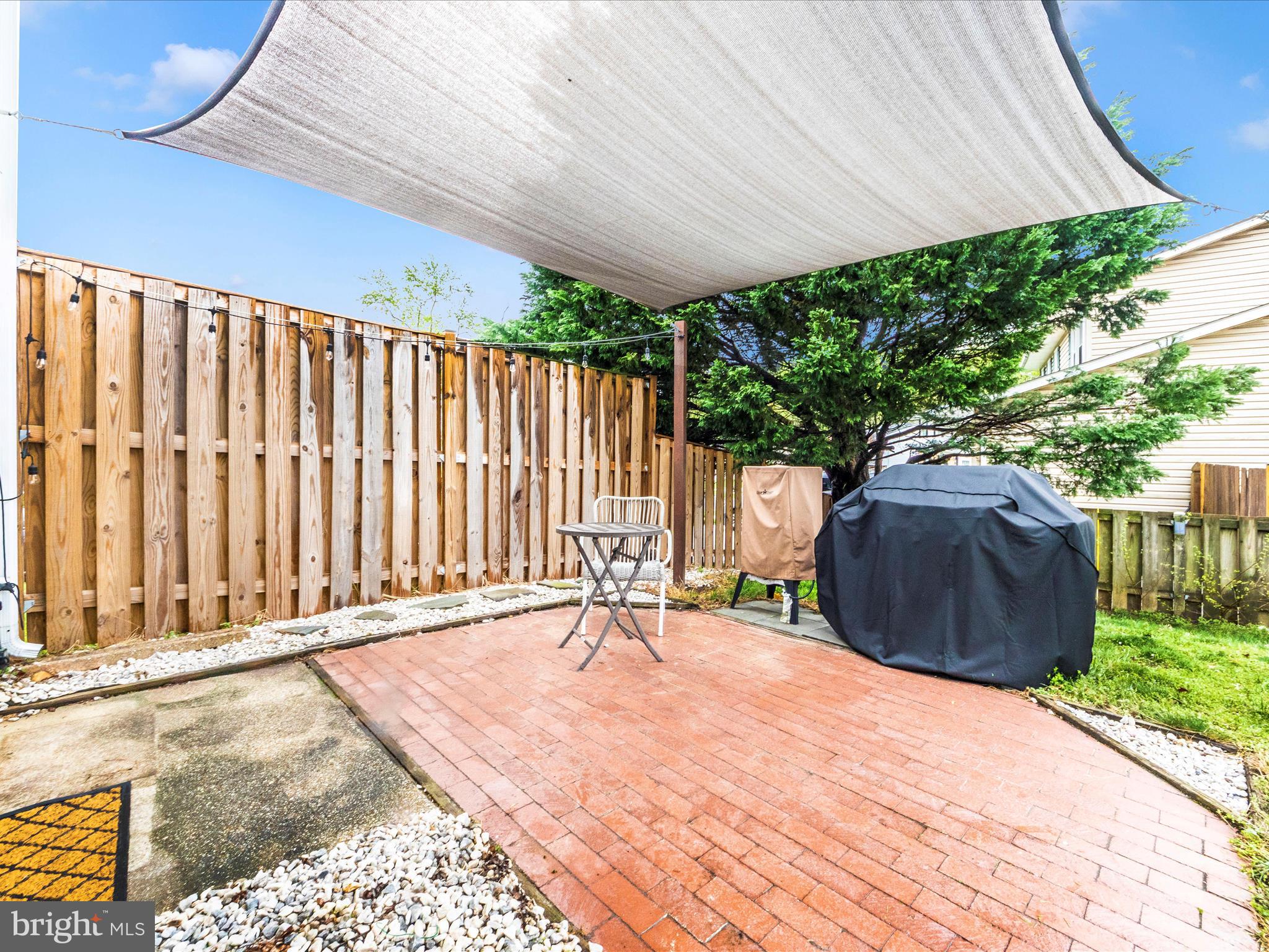 1825 Montreal Road Severn, MD 21144 - Photo 40 of 51 a backyard of a house with a garden and outdoor seating