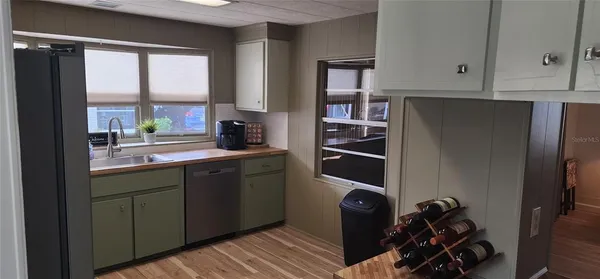 a kitchen with stainless steel appliances granite countertop a refrigerator and a sink