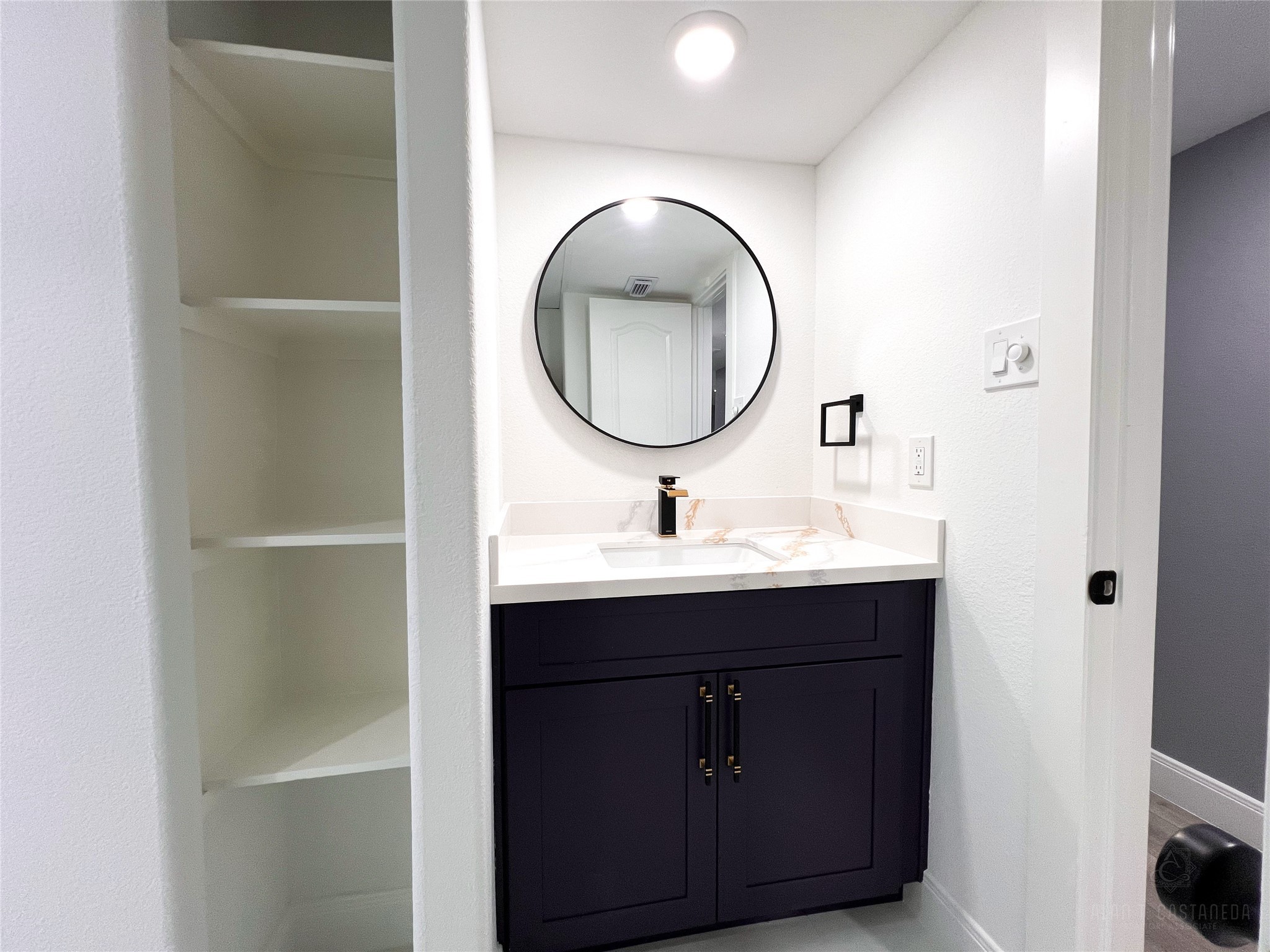 2516 Commonwealth Street, Unit 102 Houston, TX 77006 - Photo 22 of 28 a bathroom with a sink mirror and vanity