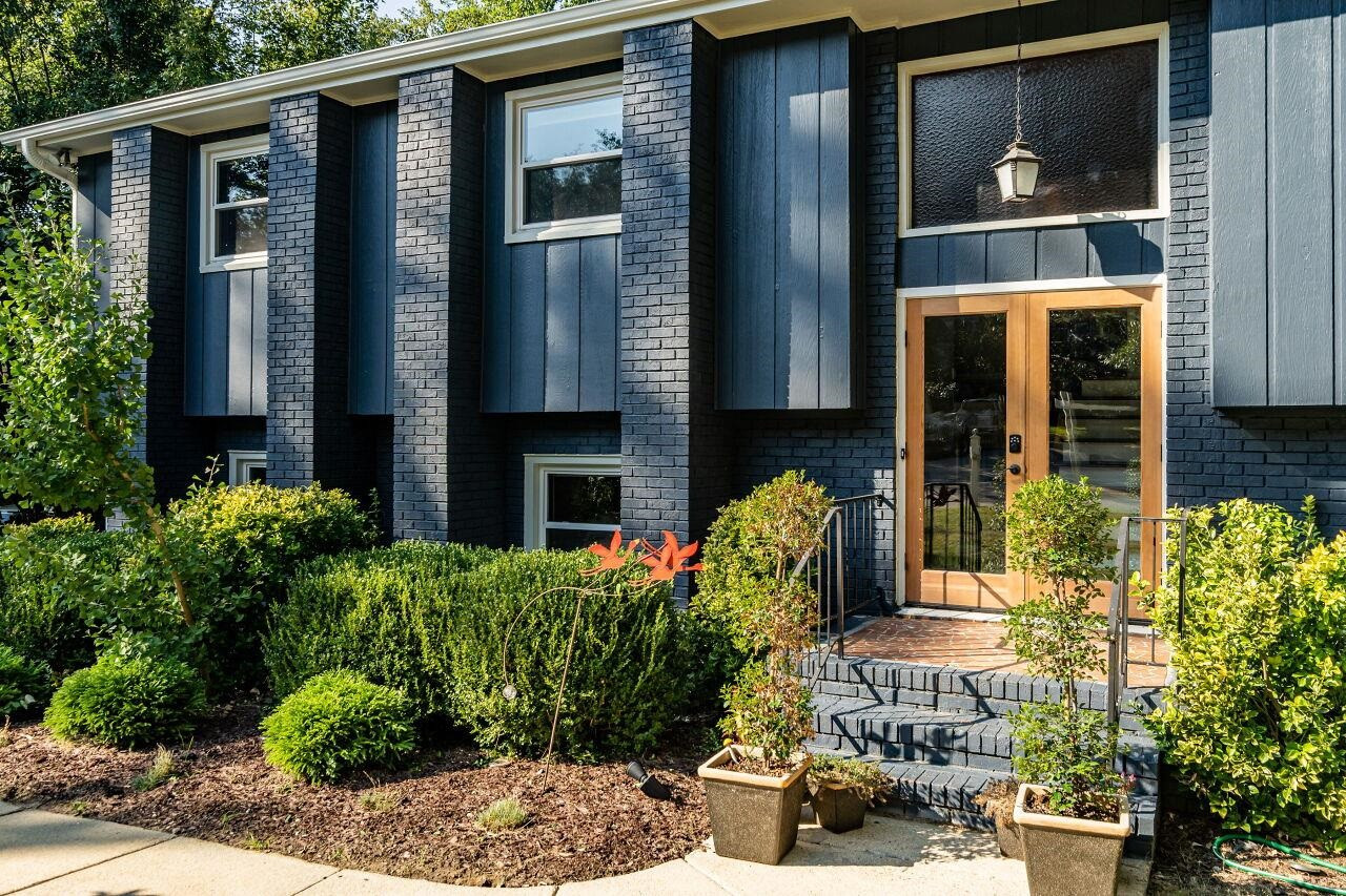 1500 Windbur Place Raleigh, NC 27609 - Photo 2 of 30 A striking double glass door package adds drama to this 70's Soft Contemporary Home Entry