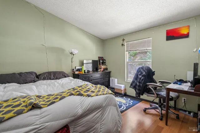 a bed room with a bed and a chair