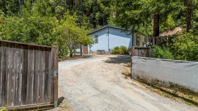 a view of a house with a backyard