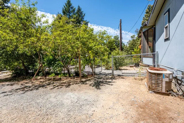a view of a backyard with wooden fence