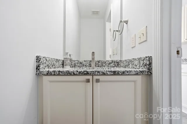 a view of a hallway with wooden floor and entryway