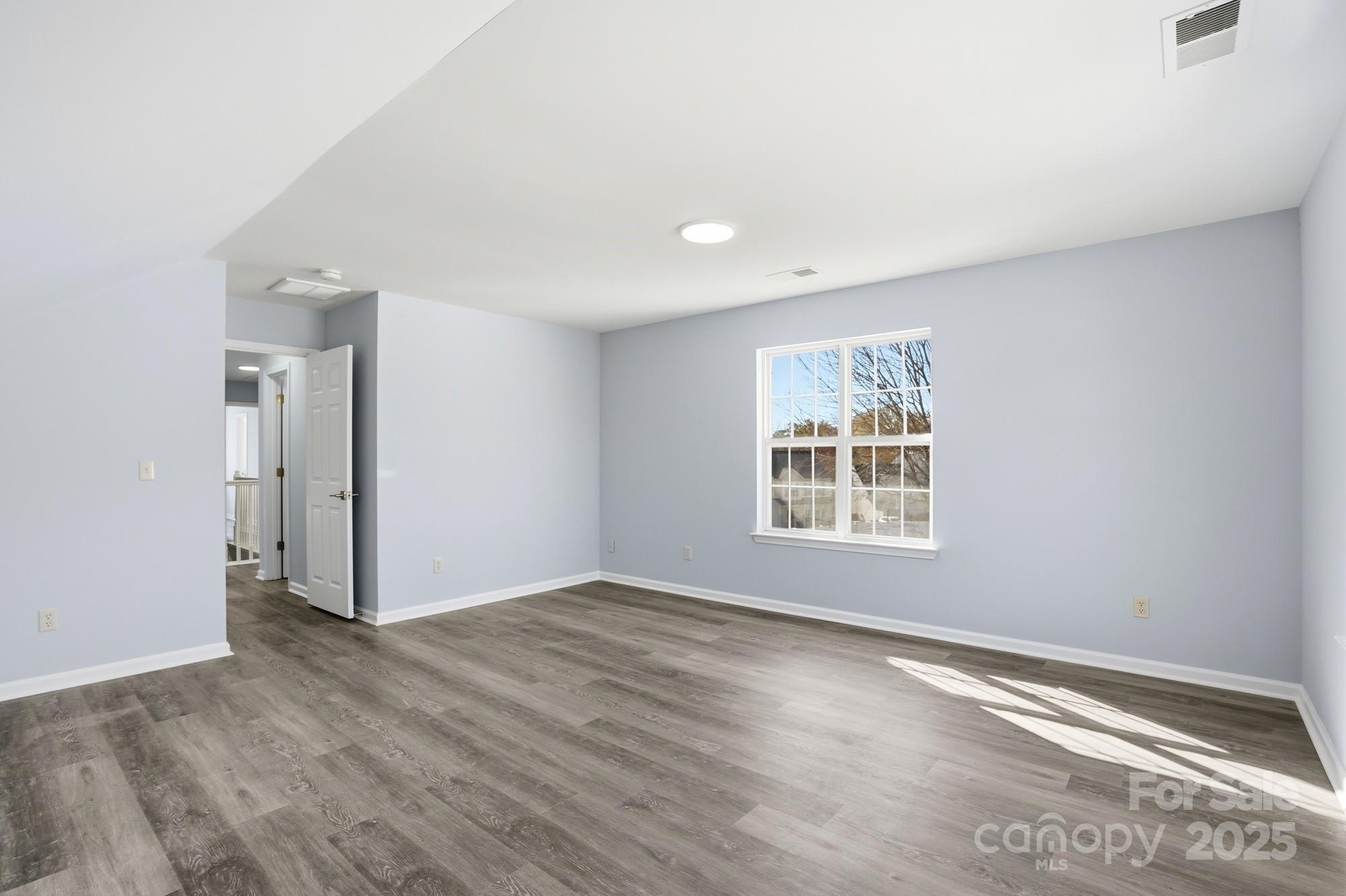 1505 Bellridge Road Rock Hill, SC 29732 - Photo 36 of 48 a view of an empty room with wooden floor and a window