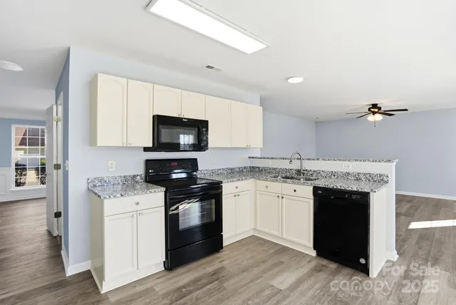 a kitchen with a stove a sink and a refrigerator