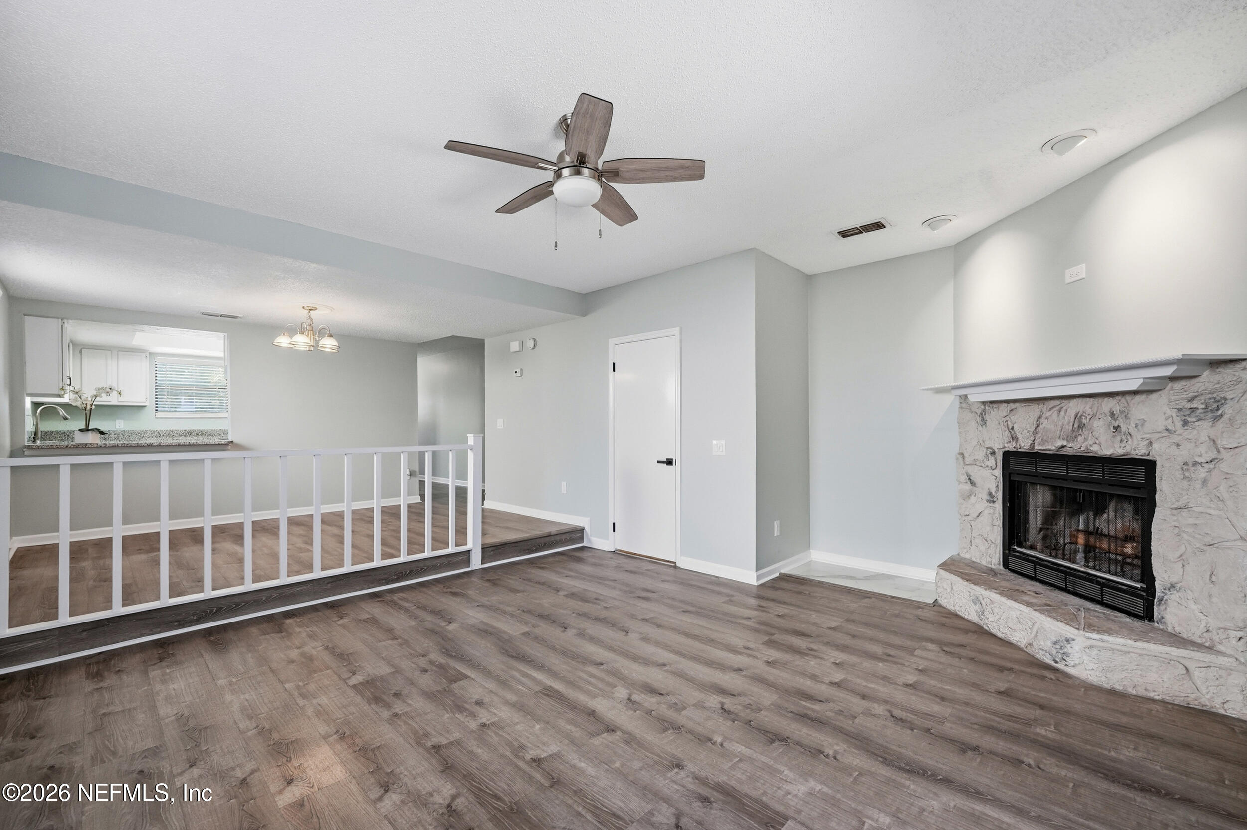 144 Poinsettia Street Atlantic Beach, FL 32233 - Photo 13 of 42 a view of a livingroom with wooden floor and a fireplace