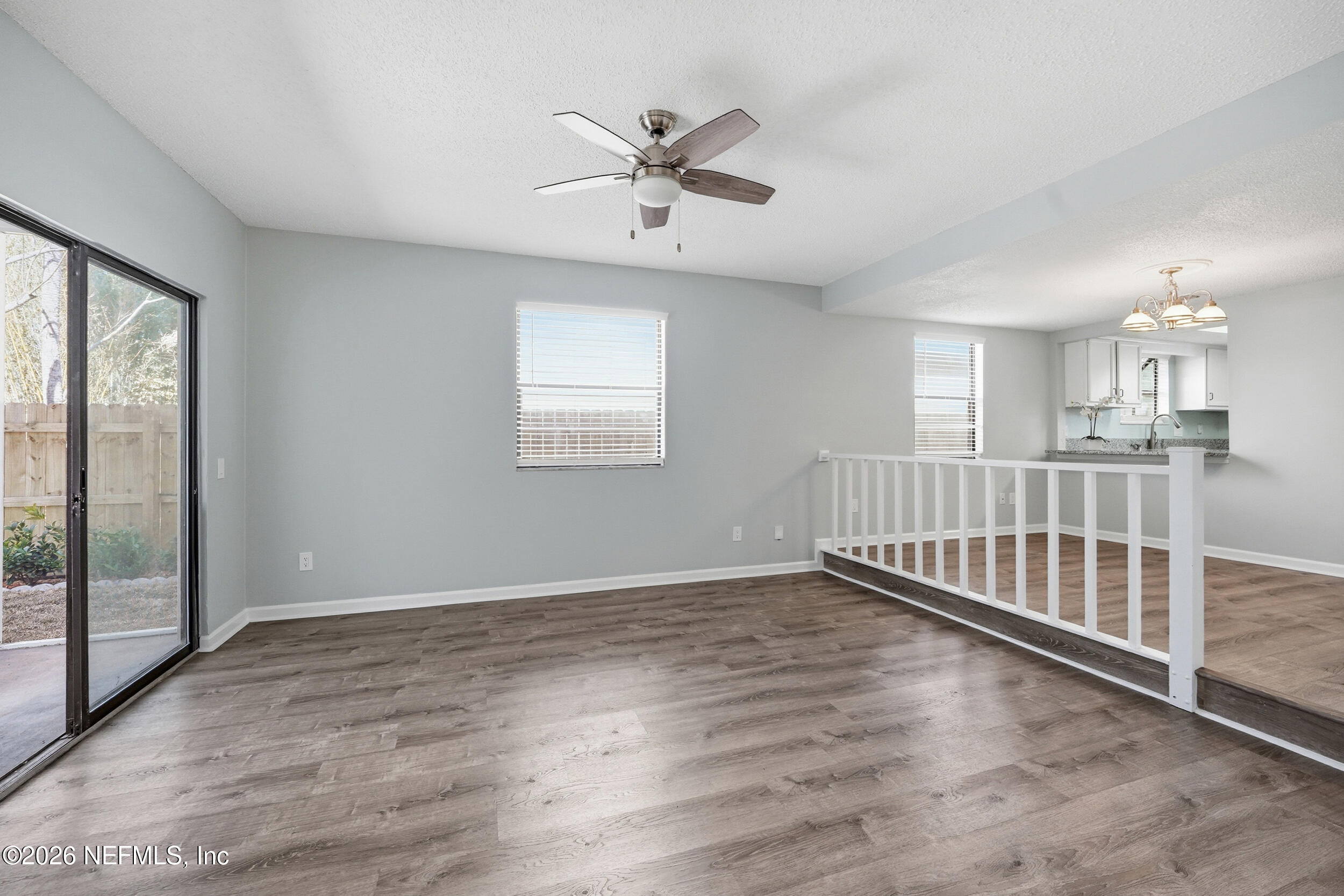 144 Poinsettia Street Atlantic Beach, FL 32233 - Photo 16 of 42 an empty room with wooden floor fan and windows