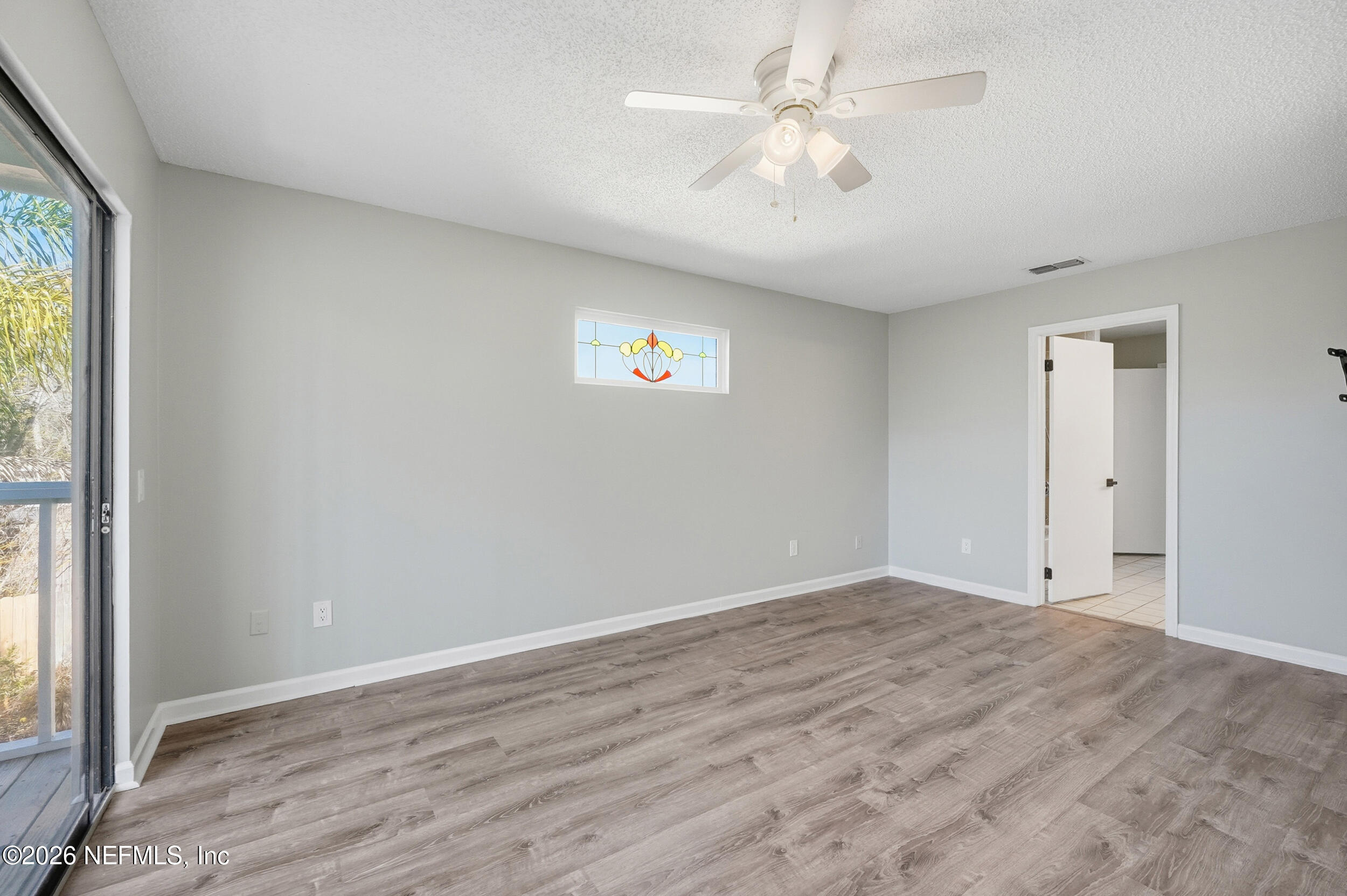 144 Poinsettia Street Atlantic Beach, FL 32233 - Photo 20 of 42 wooden floor in an empty room with a window