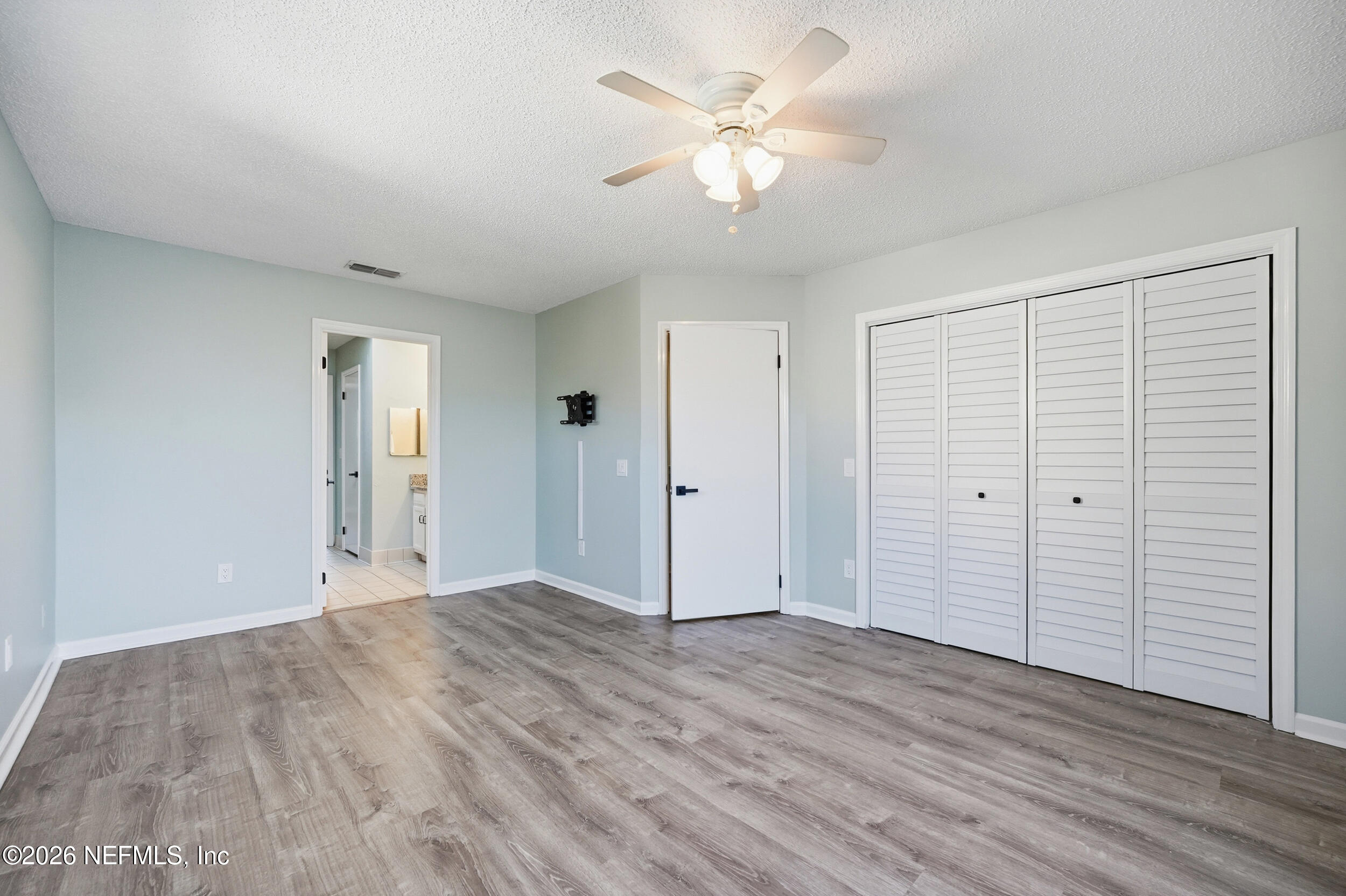 144 Poinsettia Street Atlantic Beach, FL 32233 - Photo 23 of 42 an empty room with wooden floor and window