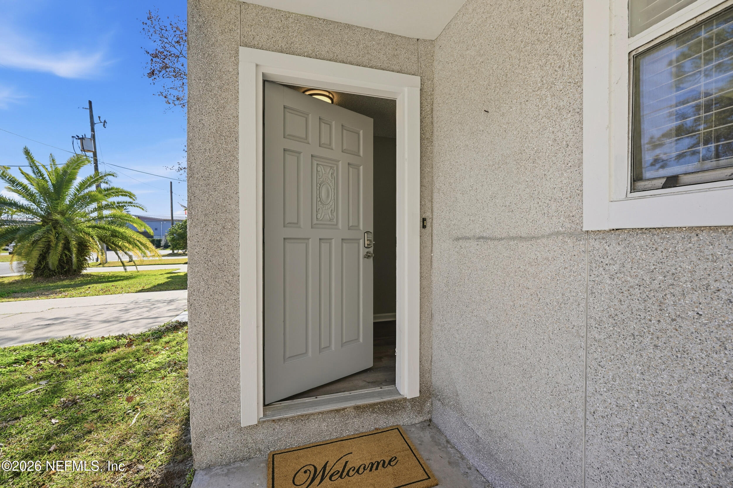 144 Poinsettia Street Atlantic Beach, FL 32233 - Photo 3 of 42 a view of an entryway with wooden floor