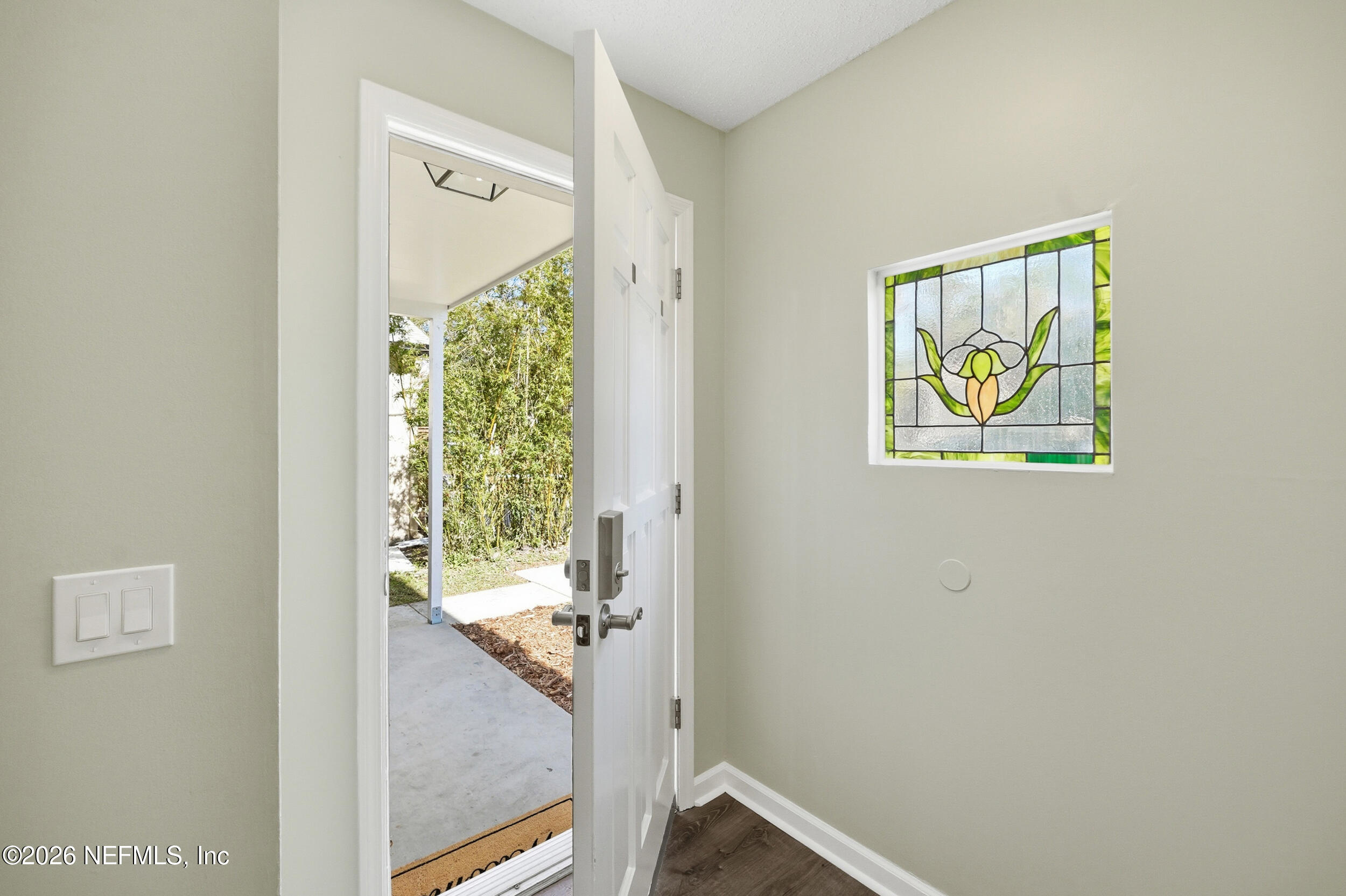 144 Poinsettia Street Atlantic Beach, FL 32233 - Photo 4 of 42 a view of a hallway with a window