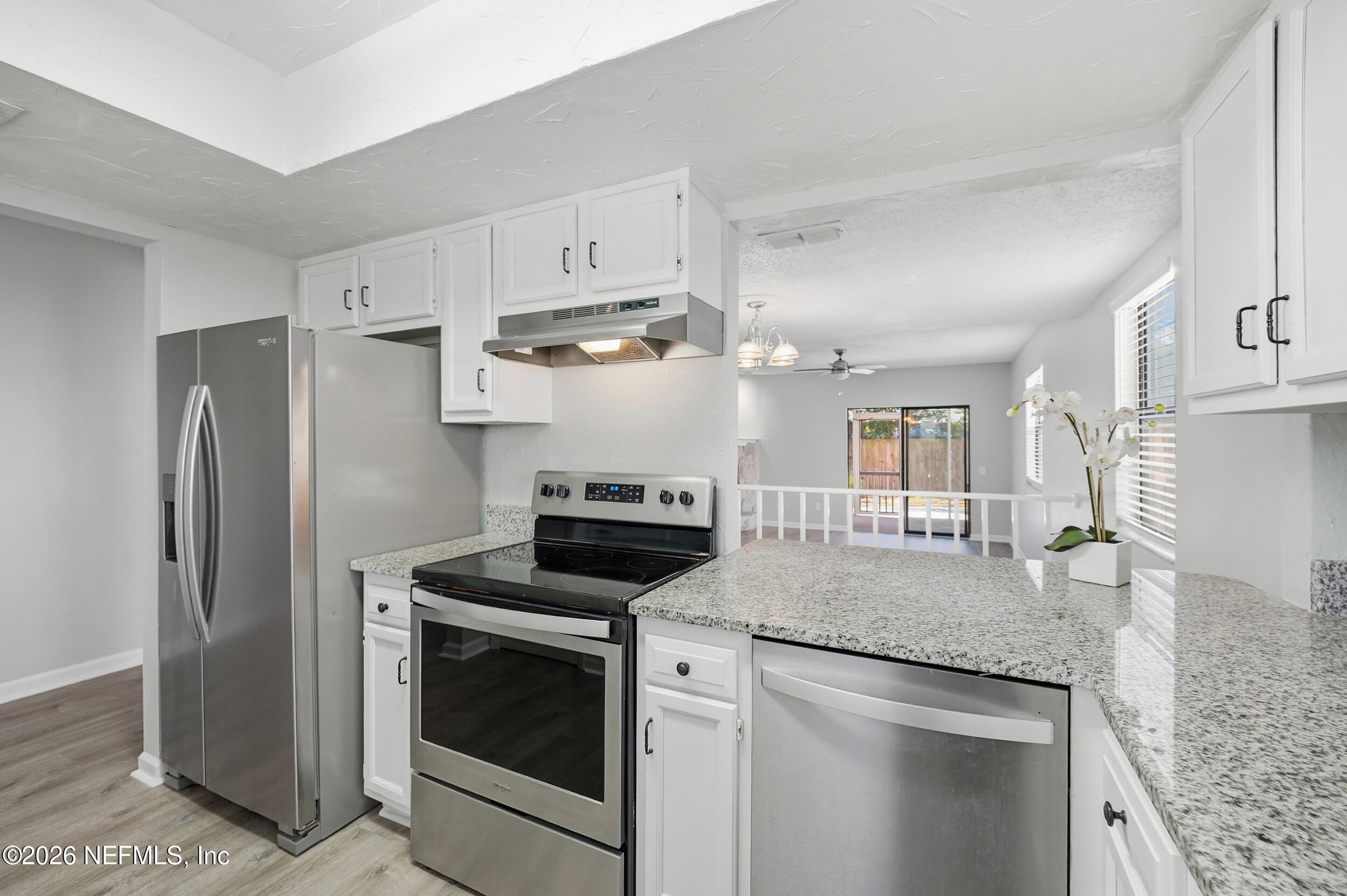 144 Poinsettia Street Atlantic Beach, FL 32233 - Photo 9 of 42 a kitchen with stainless steel appliances granite countertop a refrigerator a stove and a sink