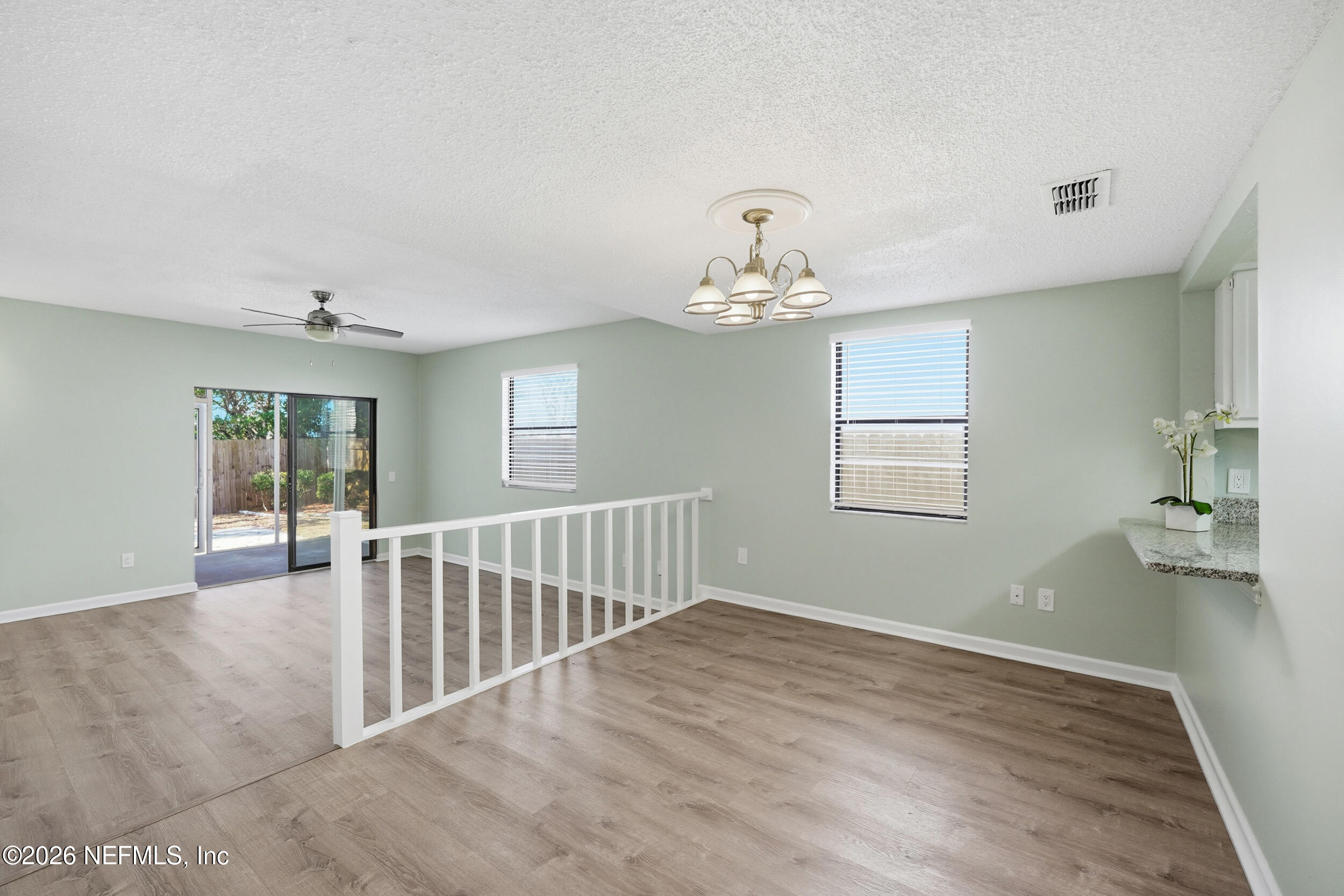 144 Poinsettia Street Atlantic Beach, FL 32233 - Photo 10 of 42 a view of an empty room with wooden floor and a window
