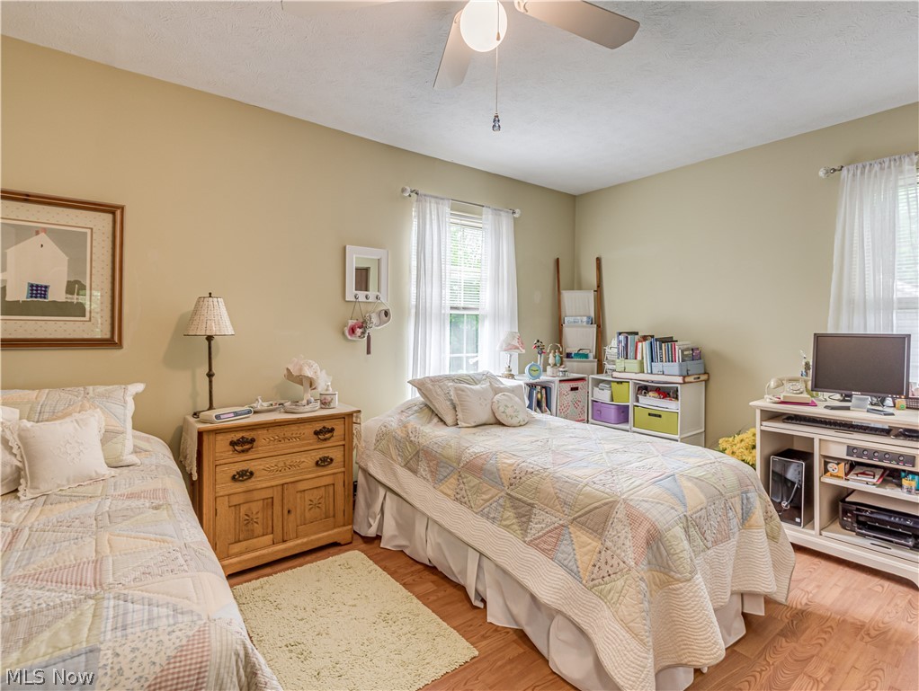 245 Perry Drive Northwest Canton, OH 44708 - Photo 16 of 25 Guest bedroom with ceiling fan and Pergo flooring.