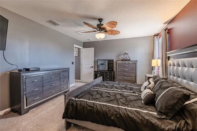 a bedroom with a bed and a dresser