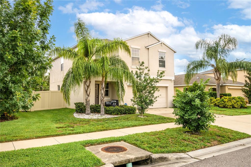 409 Serenity Ml Loop Ruskin, FL 33570 - Photo 4 of 33 a front view of a house with a yard