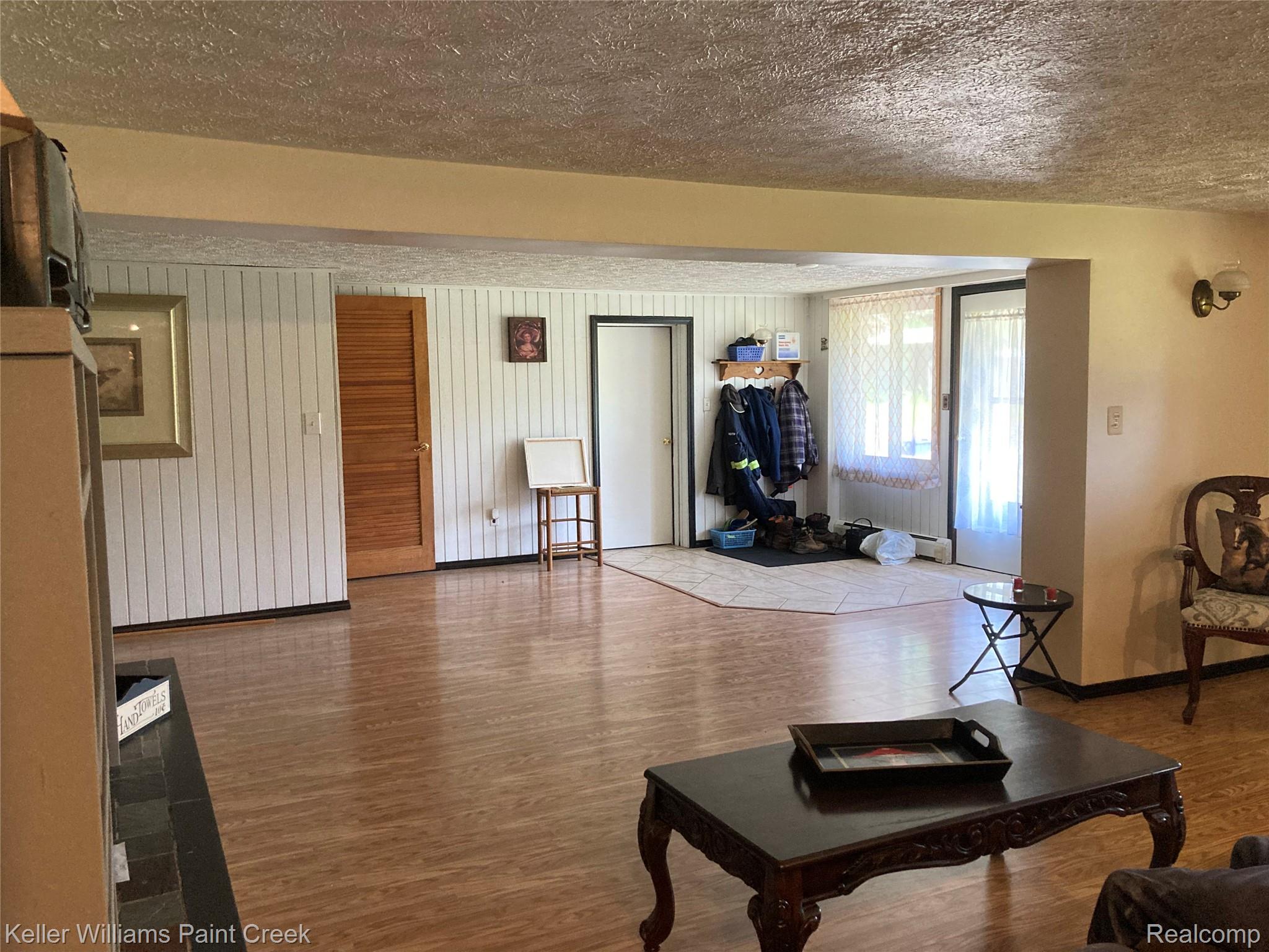 42891 Bemis Road Belleville, MI 48111 - Photo 15 of 51 Living room featuring a textured ceiling and wood finished floors