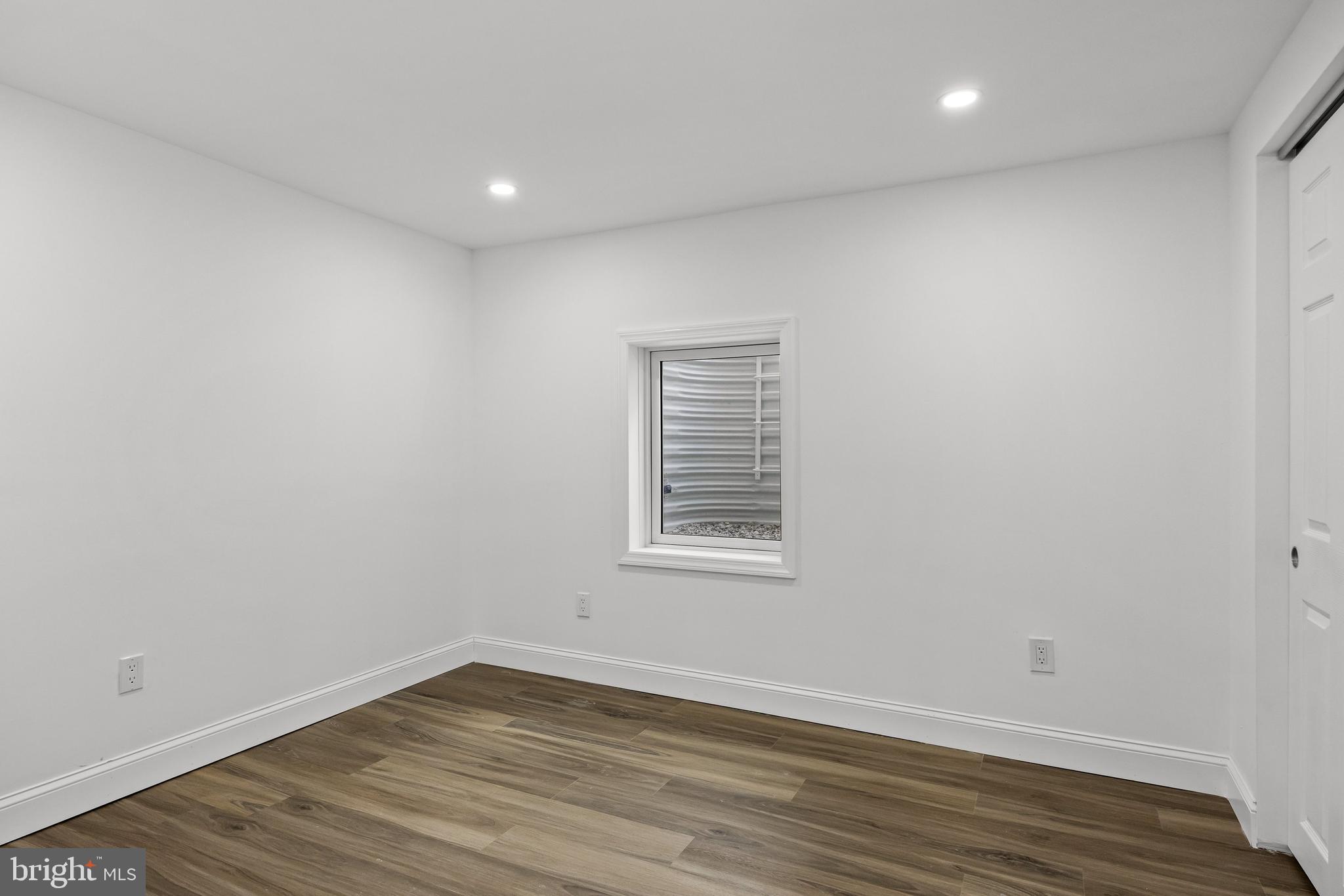 937 Clements Bridge Road Barrington, NJ 08007 - Photo 21 of 34 a view of an empty room with wooden floor and a window