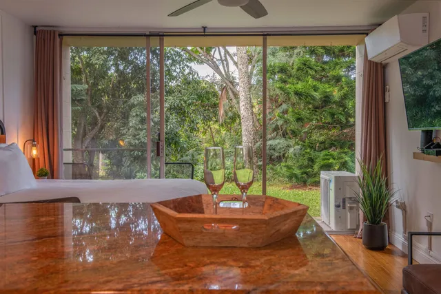 a bedroom with a large bed and a large window