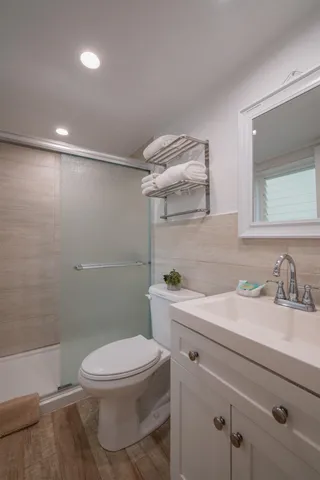 a bathroom with a toilet and a shower